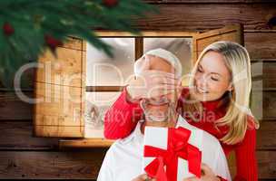 Composite image of loving couple with gift