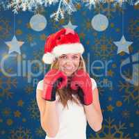 Composite image of festive blonde with boxing gloves
