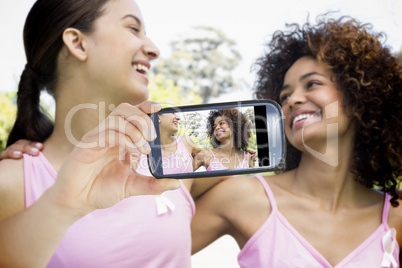 Composite image of hand holding smartphone showing