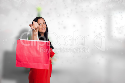 Composite image of woman standing with shopping bag