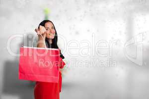 Composite image of woman standing with shopping bag