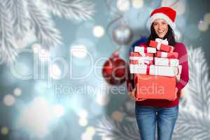 Composite image of woman holding many christmas presents