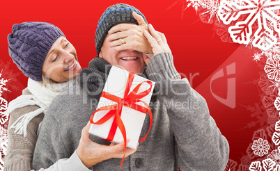 Composite image of mature woman surprising partner with gift