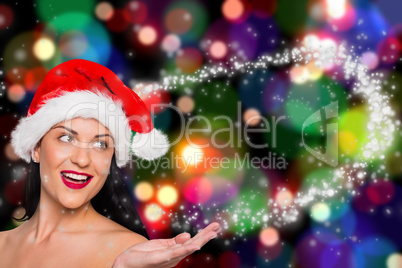 Composite image of woman wearing santa hat