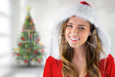 Composite image of sexy santa girl smiling at camera