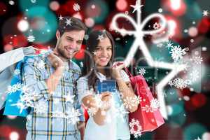 Composite image of couple with shopping bags and credit card