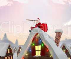 Composite image of santa sitting on roof of cottage