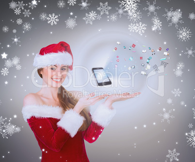 Composite image of pretty girl in santa costume holding hand out