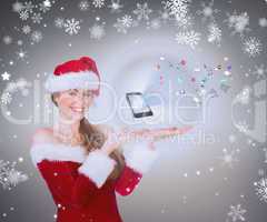 Composite image of pretty girl in santa costume holding hand out