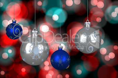 Composite image of blue and silver christmas baubles