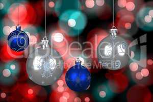 Composite image of blue and silver christmas baubles