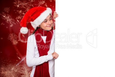 Composite image of festive little girl showing card