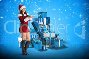 Composite image of pretty girl in santa costume holding hand out