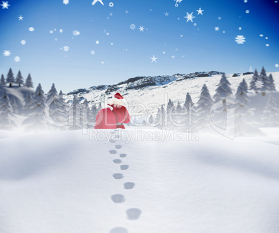 Composite image of santa walking in the snow