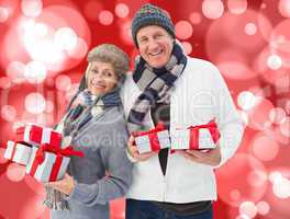 Composite image of festive mature couple holding christmas gifts