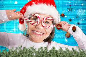 Composite image of festive little girl smiling at camera