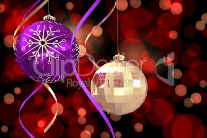 Composite image of hanging christmas bauble decorations