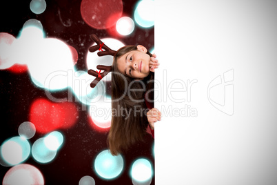 Composite image of festive little girl showing card