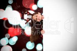 Composite image of festive little girl showing card