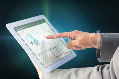 Composite image of businesswoman using a tablet pc