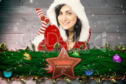 Composite image of pretty girl smiling in santa outfit