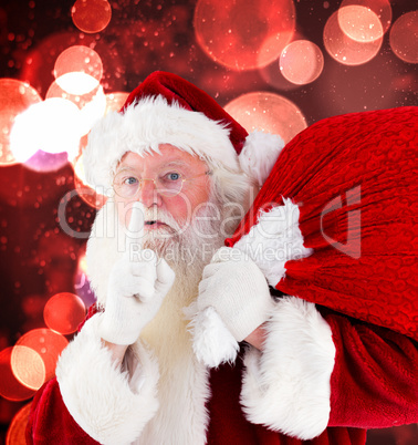 Composite image of santa claus carrying sack