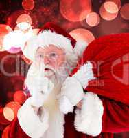 Composite image of santa claus carrying sack