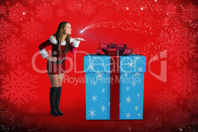 Composite image of sexy santa girl blowing a kiss