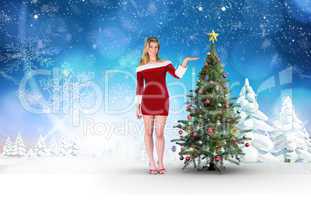 Composite image of pretty girl presenting in santa outfit