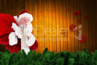 Composite image of santa claus carrying sack