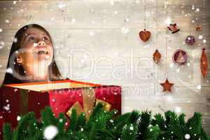 Composite image of happy girl opening gift box