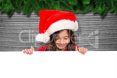 Composite image of festive little girl showing card