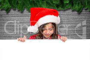 Composite image of festive little girl showing card