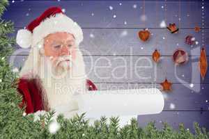 Composite image of santa claus checking his list