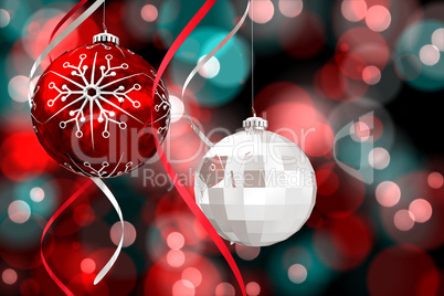 Composite image of hanging christmas bauble decorations