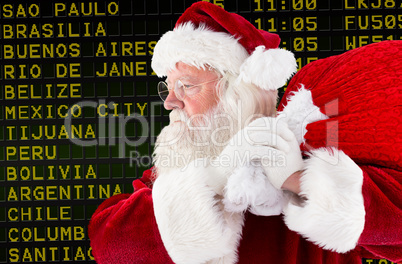 Composite image of santa claus carrying sack