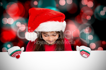 Composite image of festive little girl showing card