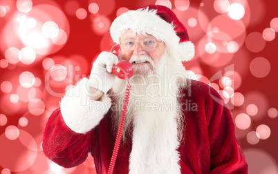 Composite image of santa claus on the phone