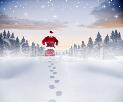 Composite image of santa walking in the snow