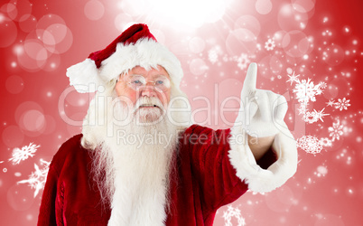 Composite image of santa claus pointing