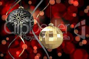 Composite image of hanging christmas bauble decorations