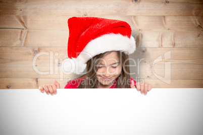 Composite image of festive little girl showing card