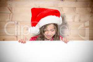 Composite image of festive little girl showing card