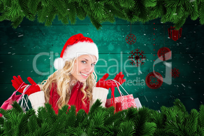 Composite image of happy festive blonde with shopping bags