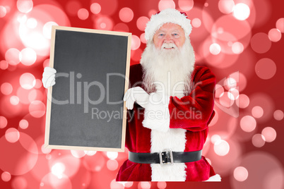 Composite image of santa claus showing blackboard