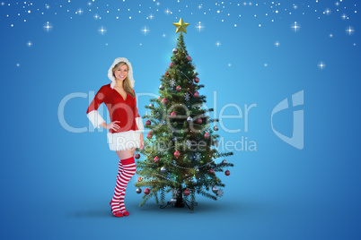 Composite image of pretty girl smiling in santa outfit