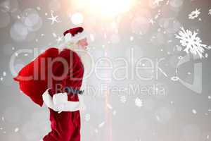 Composite image of santa claus carrying sack