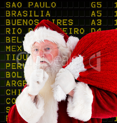 Composite image of santa claus carrying sack