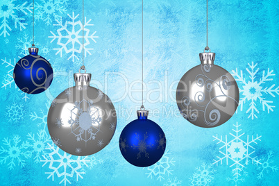 Composite image of blue and silver christmas baubles