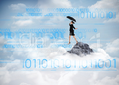 Composite image of young businesswoman holding umbrella